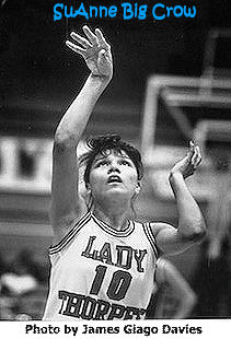 Image of SuAnne Big Crow, shooting a foul shot in her #10 uniform for Pine Ridge School, c.1989. Photo by James Fiago Davies.