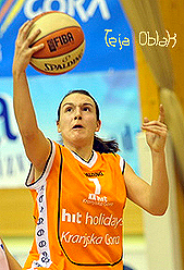 Image of SKL 2009-10 MVP, Teja Oblak, going up for a layup in her orange Kranjska Gora unform, number 1.