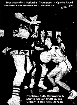 AP Wirephoto from the February 25, 1953 Mason City Globe-Gazette, of an Iowa State Girls' Basketball Tournament opening round game on 2/24/1953. Pcictured is small forward, sophomore Amy Jensen of the Gilbert High team about to attempt to shoot, with huge Ruth Dohrmann of Franklin Consolidated towering over her, coming in to block, as is #30, Marlys Stover of Franklin. The final score was Franklin 60, Gilbert 48.
