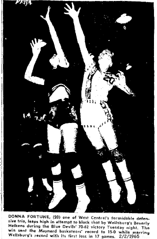 Donna Fortune, West Central High jumping to attempt block of Wellsburg's Beverly Heikens, in an Iowa 6-on-6 basketball game on February 2, 1965; the Blue Devils of Maynard won 70 to 62 to make their record 15-0, it was Wellsburg's first loss in 17 games. Oelwein Daily Register, 2/2/1965.