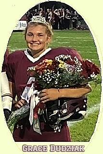 Image of Grace Dudziak, Wellington High School (Ohio) homecoming queen and football place kicker, in uniform with tiara, sash and roses.