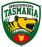 Gridiron Tasmania logo. A shield with white background and green trim, a golden Tasmanian Devil head and neck in profile, facing right, three black stripes, open mouth whith pointy teeth, a grassy green turf and a red football with a golden yellow map of Tasmania island in its center, GRIDIRON TASMANIA written above.