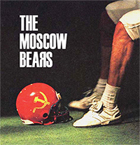 The Moscow Bears promo. Legs with uniform cut-off at knees, sitting on bench with football helmet with hammer and sickle logo.