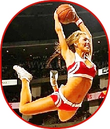 Photo of a cheerleader in red uniform, in the  air as if to dunk a basketball.