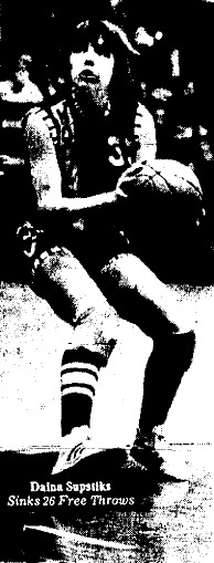 Picture of Daina Sustiks, Hoover High Huskies Iowa 6-on-6 girls' basketball player, looking for a shot during her Metropolitan Conference girls basketball record 82 point game at Roosevelt High, February 4, 1977. Des Moines Register Peach, February 5, 1977.